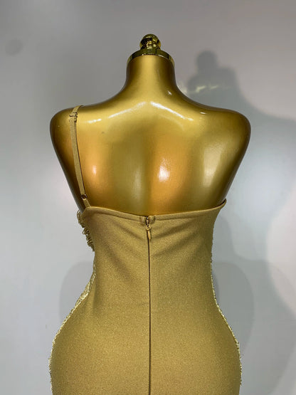 MC Women backless gold bodycon bandage dress with tassel details, designed by MC THE BLACK DIAMOND, showcasing a stylish, fitted silhouette.