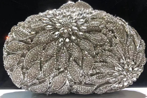 Gold metal leaves and white crystal evening clutch bag by MC THE BLACK DIAMOND, featuring a mini heart design and rhinestone accents.