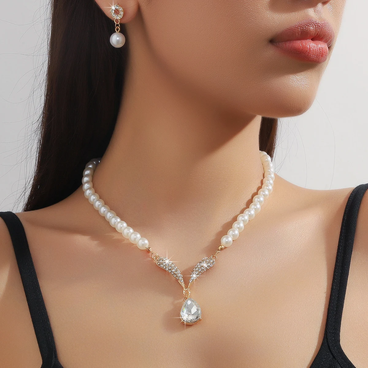 Golden 3-piece pearl droplet necklace and earrings set by Mohammad Collection, elegant jewelry for weddings and special events.